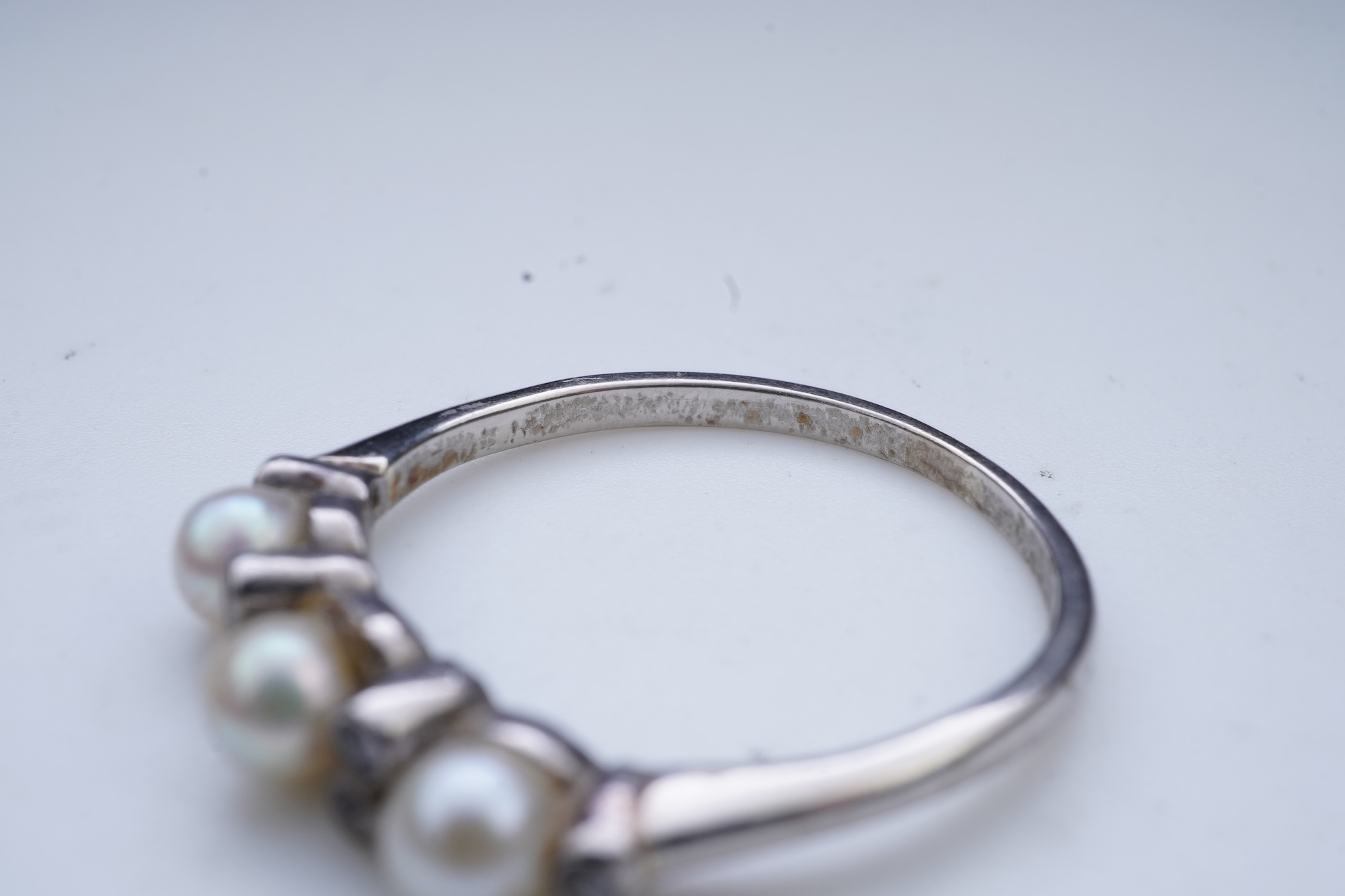 An Edwardian seed pearl brooch and a pearl and diamond ring